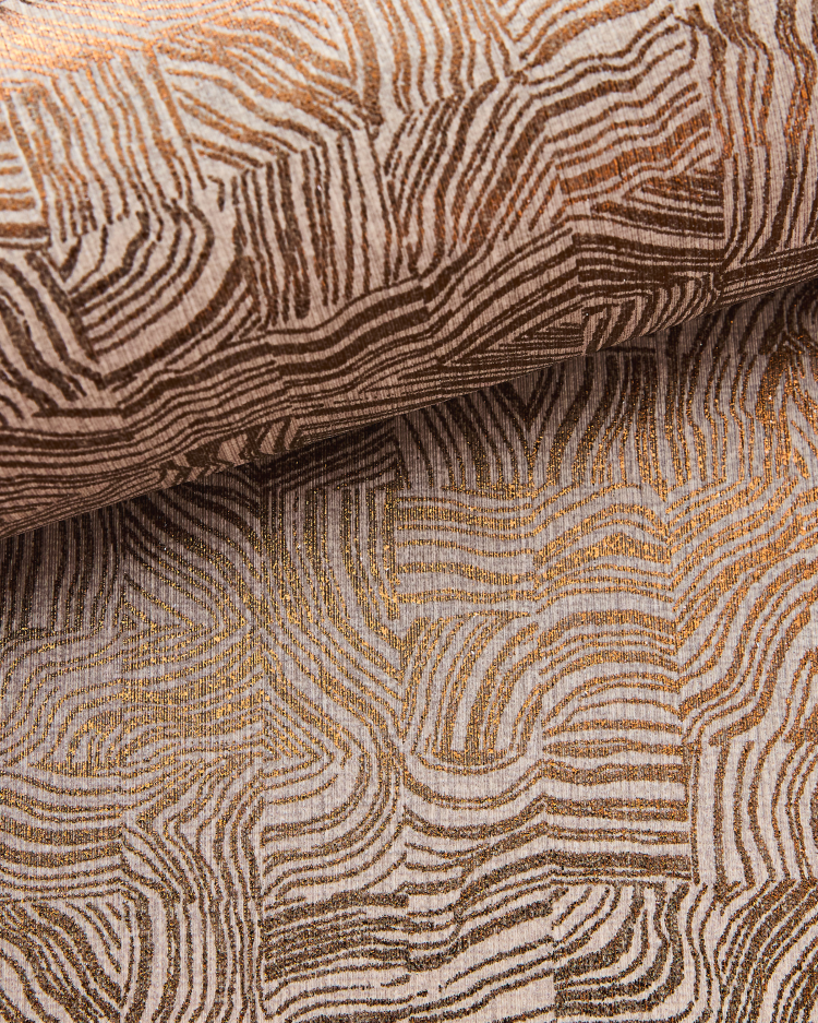 detaljbilde av et tekstiltapet med trykt mønster 